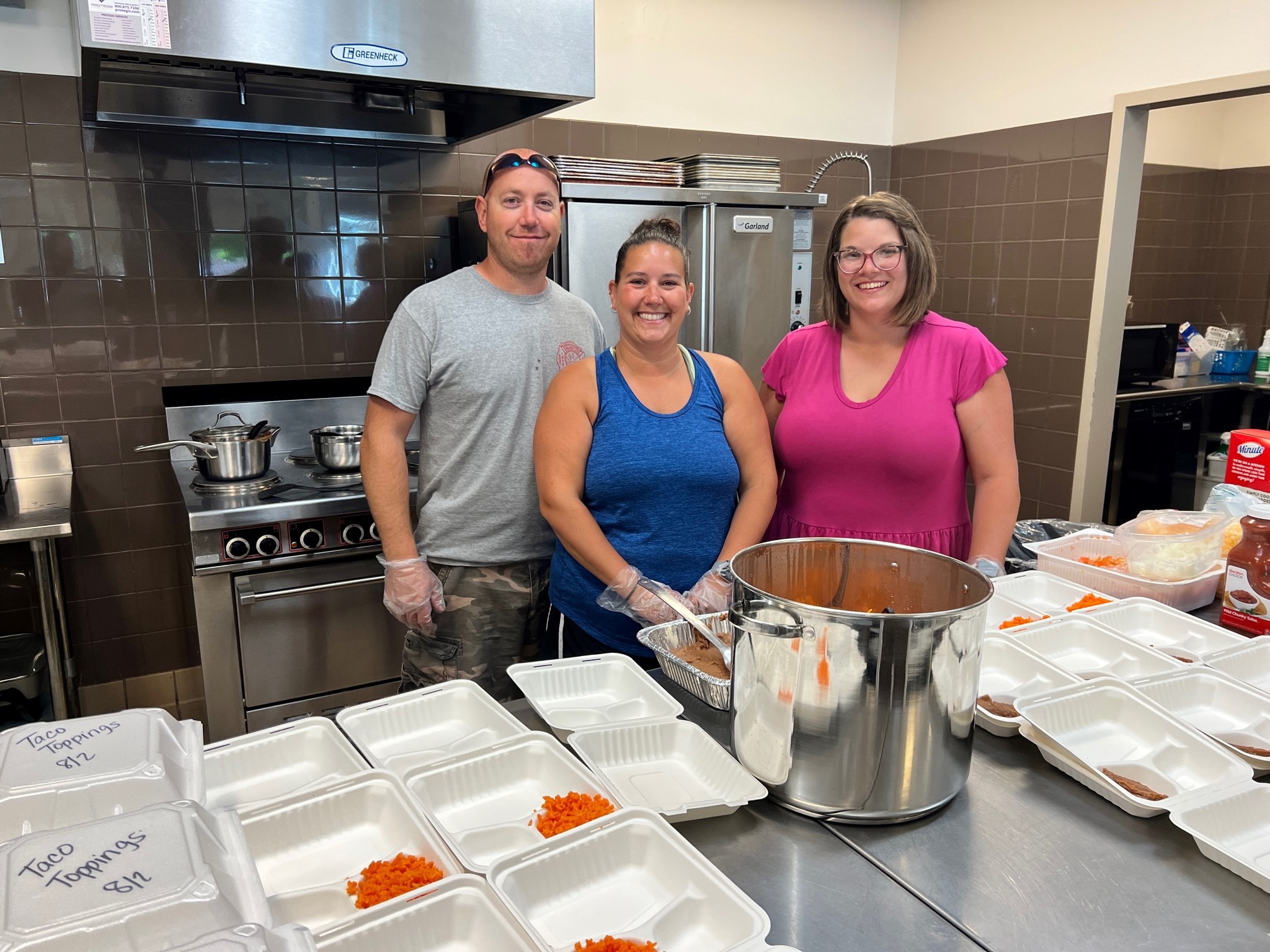 Jordan Wax, Michelle Wax, and Katie Neisler volunteering at the Ronald McDonald House.